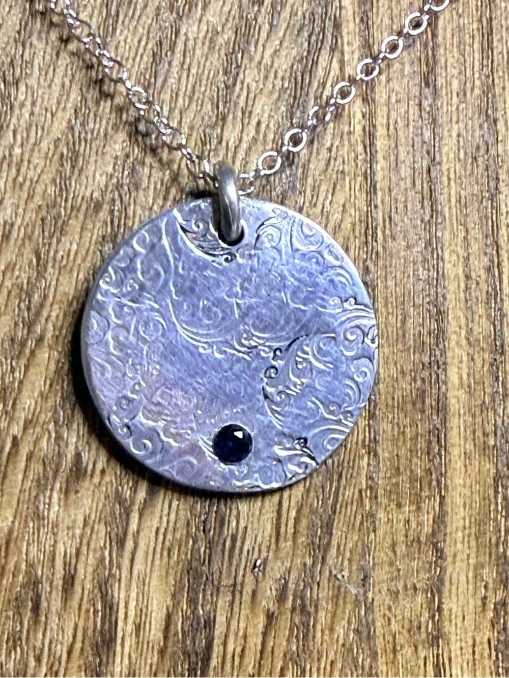 Floral Disc pendant with small sapphire
